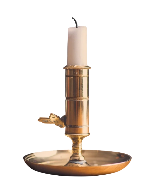Unlit candle in a brass holder